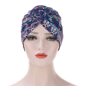 Close-up of ethnic floral print turban hat in navy blue with spiral twist detail