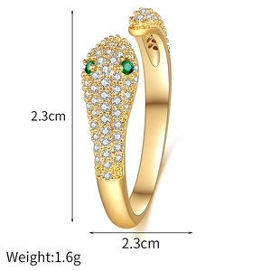 Macro shot of gold snake ring with white and green zircons showing 2.3cm height dimension
