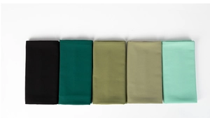 Detail view of pearl chiffon hijabs in black, olive, and mint green on a white background