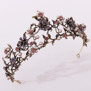 Close-up of floral bridal crown with white pearls and pink rhinestones on bronze metal
