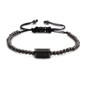 Macro detail of men's beaded bracelet with black pavé stones and adjustable cord
