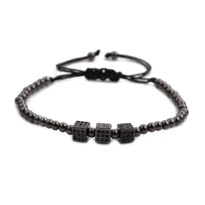 Close-up of black braided beaded bracelet featuring three micro-pave cubic zirconia cubes