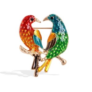 Elegant gold-tone bird brooch with vibrant multi-color enamel and sparkling rhinestones