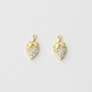 Detailed macro shot of 18k gold strawberry pendants with micro-paved cubic zirconia