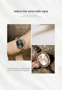 Detail view of oval rose gold watch featuring sparkling crystals and brown leather strap