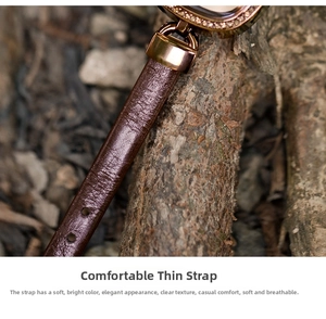 Macro shot of dark brown leather watch strap with elegant diamond-encrusted rose gold buckle
