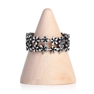 Vintage silver flower ring displayed on a solid wood cone stand with white background