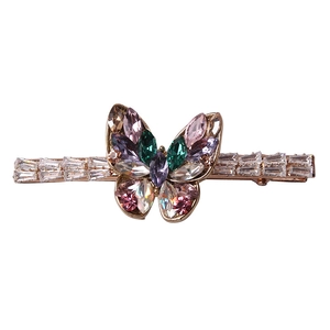Sparkling butterfly hair clip with colorful zircon crystals and golden metal base on white
