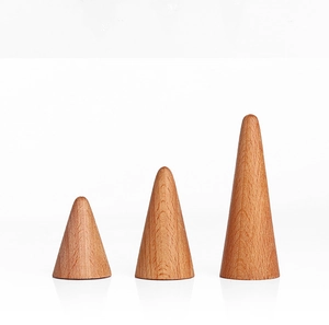 Three conical solid wood ring display stands with natural grain texture on white surface