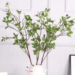 Artificial Milan leaf branches in vintage ceramic vase for home interior greenery decor