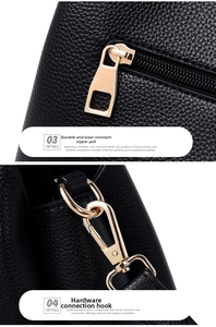 Detail of premium black lychee leather with golden zipper and sturdy metal hook