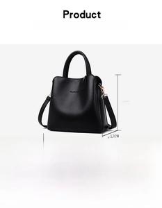 Detailed view of black litchi grain leather handbag with CLASSIC logo and metal buckle