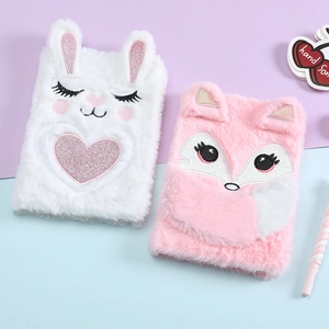 Flat lay of cute plush bunny and fox notebooks with embroidery and fluffy texture