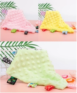 Detail of colorful ribbon tags and textured minky fabric on soft baby security blankets