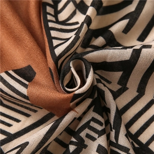 Detail shot of lightweight cotton-linen scarf with geometric patterns and soft texture