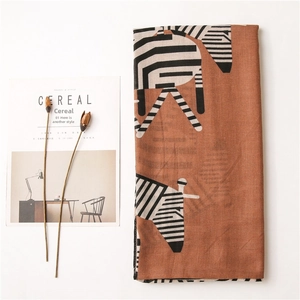 Detailed texture of lightweight terracotta zebra print scarf with soft fabric edges