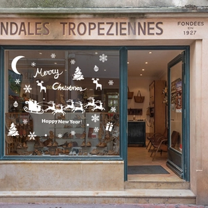 White Christmas window stickers with Santa sleigh, reindeer and snowflakes on glass
