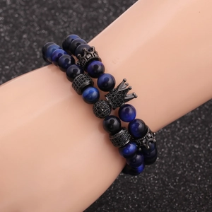 Blue tiger eye beaded bracelet set with crown charm on model wrist, elegant jewelry