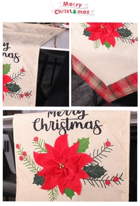 Close-up of red poinsettia applique and stitching on beige Christmas table runner