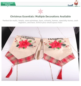 Detail view of beige Christmas table runner with red flowers, plaid ends, and silk tassels