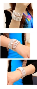 Detail of multi-layer pearl bracelet with rhinestones worn on a female wrist