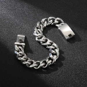 Detailed close-up of a high-polished silver Cuban link bracelet on a black matte surface