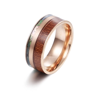 Detail of 9mm rose gold titanium ring with wood inlay and iridescent abalone shell