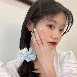 White organza floral scrunchie with blue embroidery flowers worn on a side ponytail