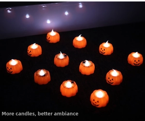 Close-up of Halloween LED pumpkin candle lights with spider web and jack-o-lantern patterns