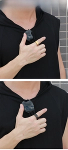Detail view of gold and gunmetal rectangular signet rings on fingers for men
