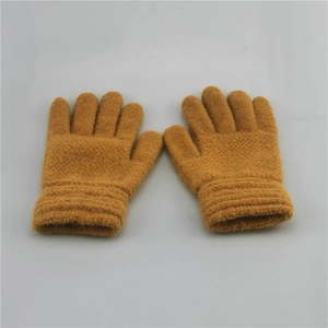 Detailed close-up of brown knitted winter gloves with elastic ribbed cuffs for kids