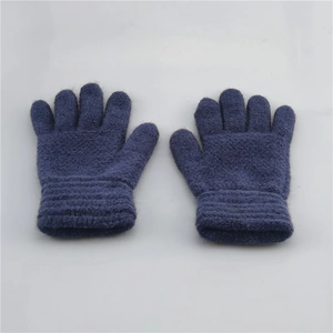 Detailed view of blue knitted winter gloves for kids with ribbed cuffs on gray background