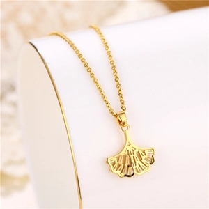 18K gold plated titanium necklace featuring a hollow fan-shaped zircon pendant on a display