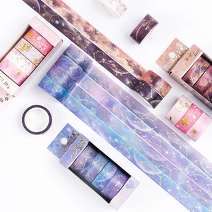 Macro view of assorted washi tape rolls with starry sky and cherry blossom patterns