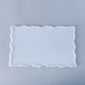 Close-up of a translucent rectangular silicone mold with wavy edges for resin DIY crafts