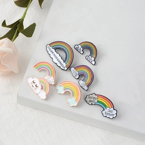 6-piece creative rainbow enamel brooch set with clouds and motivational slogans on white stand