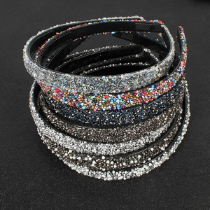 Detail view of multi-style headbands featuring rhinestones, pearls, and colorful beads