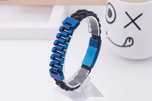 Detail of blue metal segments and black braided leather strap on a men's bracelet