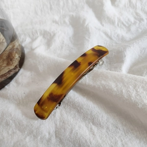 Detail of tortoise shell acrylic hair clip with vintage pattern and metal spring clip