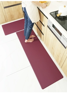 Detail of wine red kitchen mat set with waterproof PU leather and anti-slip texture