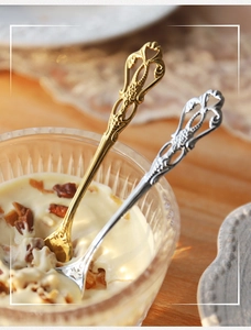 Macro detail of retro European gold and silver spoons with vintage embossed handles