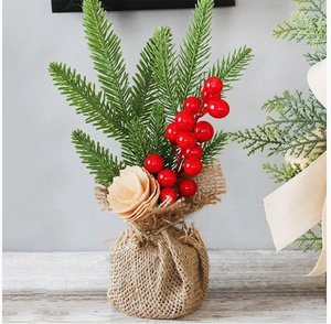 Detail of 25cm mini Christmas tree with red berries, pine needles and burlap base