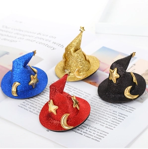 Close-up of glittery mini witch hats with gold stars and moon patterns in four colors