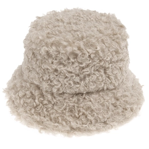 Close-up of curly lambswool texture on a beige fuzzy bucket hat for winter fashion