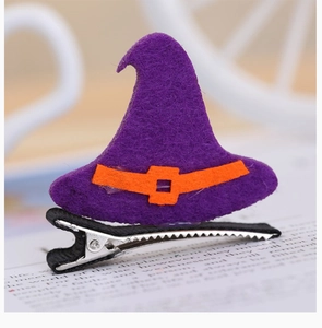 Detailed close-up of a purple felt witch hat hair clip with an orange decorative band