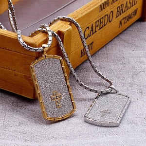 Close-up of gold and silver stainless steel dog tag necklaces with cross pattern