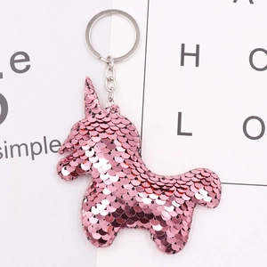 Pink sequin unicorn keychain with silver ring on a white minimalist background