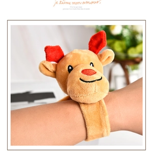 Close-up of a plush reindeer snap bracelet worn on wrist for Christmas decorations