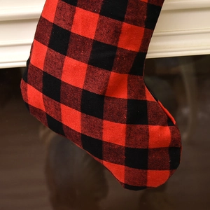 Close-up of red and black buffalo plaid Christmas stocking with plush trim detail