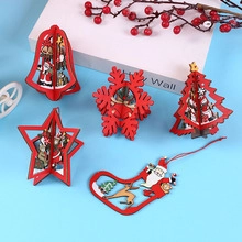 Detail of red and natural wood Christmas ornaments in bell, tree, and star shapes